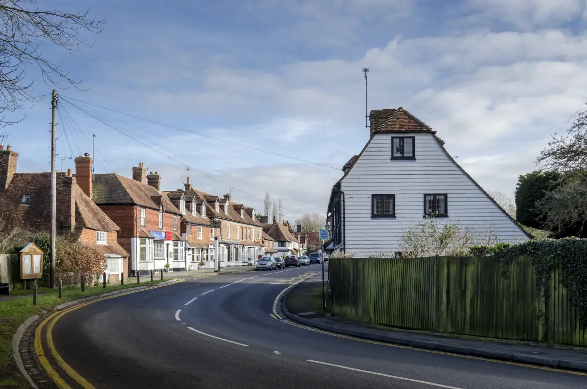 Historic high street with timber houses in the Sherborne area served by Excel Taxi