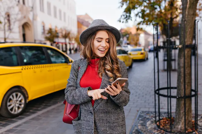 Business traveller booking an Excel Taxi Yeovil corporate ride on her phone