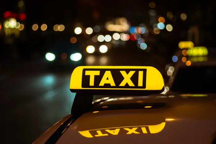 Excel Taxi Yeovil taxi sign lit up at night for a late journey
